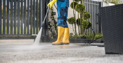 A person cleaning and maintaining their aggregate driveway